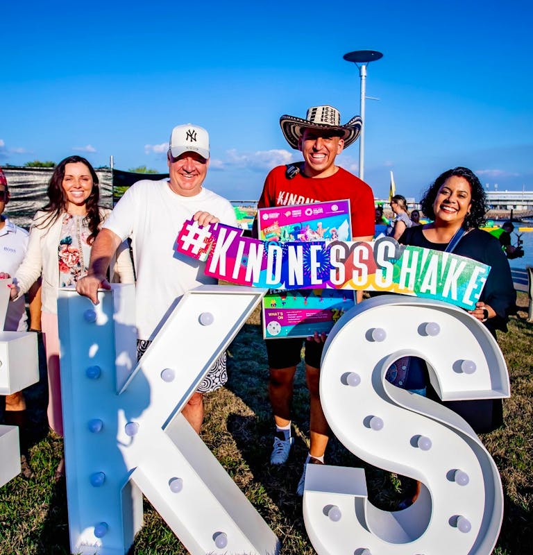 Kindness Shake co founder and stakeholders posing behind Kindess Festival letters
